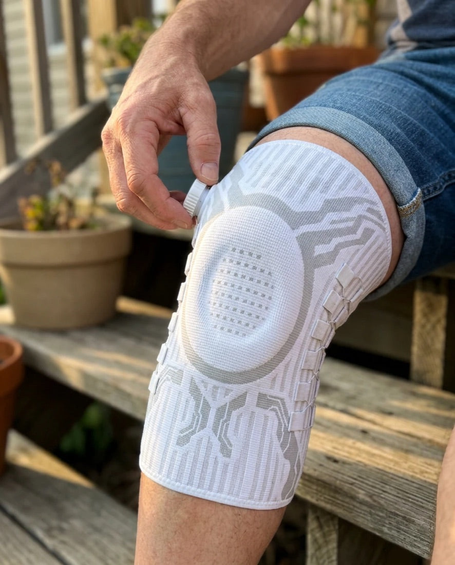 Hand turning the dial on a white Chipaki knee brace