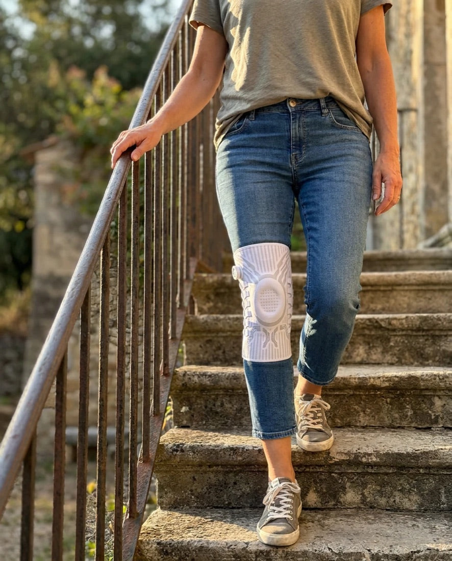 Woman walking down old stone steps wearing a white Chipaki knee brace