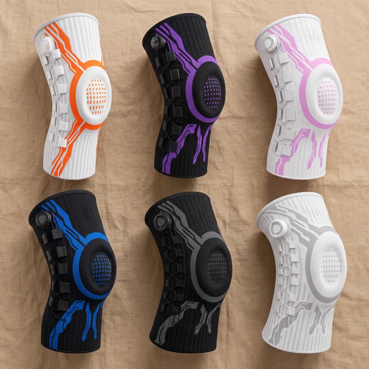 Six Chipaki knee braces laid flat: orange, purple, pink, blue, gray and white